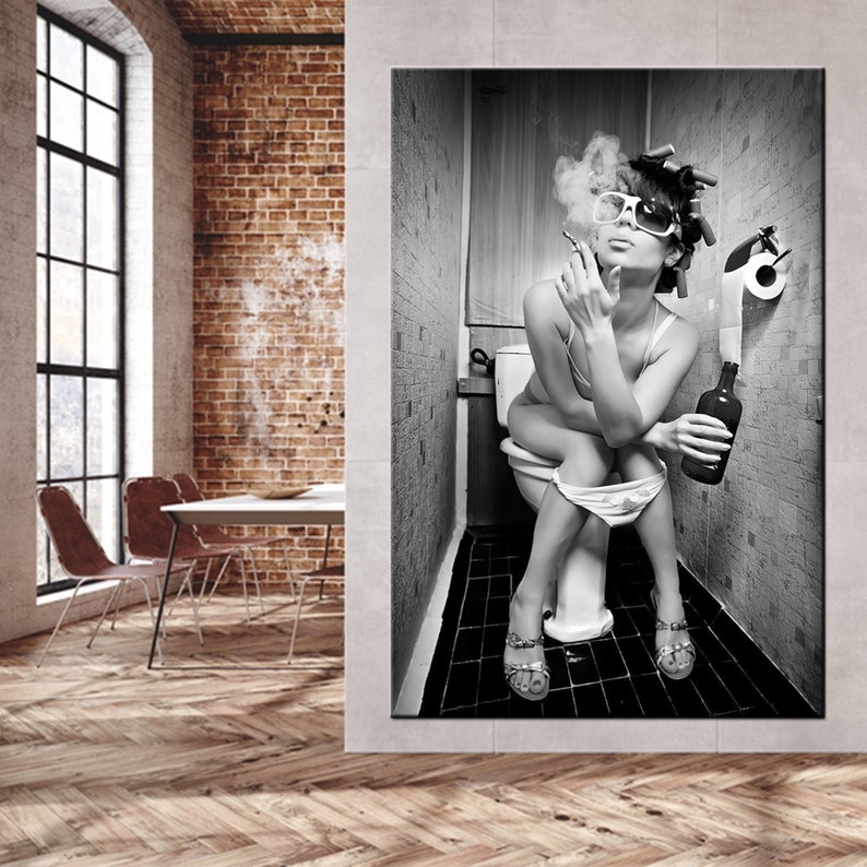 May include: Black and white print of a person sitting on a toilet, smoking a cigarette, and holding a bottle. The person is wearing sunglasses and curlers. The background is a bathroom.