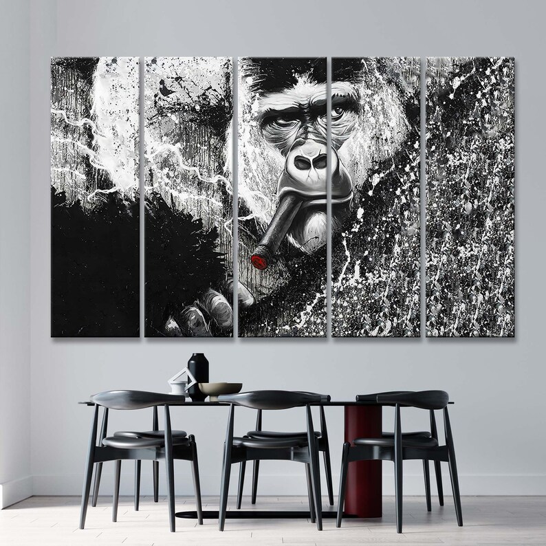 May include: A black and white multi-panel canvas print featuring a gorilla smoking a cigar. The gorilla's face is in the center of the print, and the background is a splatter of white paint on a black background.