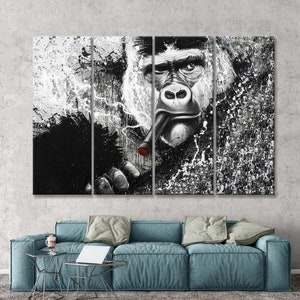 May include: A black and white multi-panel canvas print featuring a close-up of a gorilla's face with a lit cigar in its mouth. The background is a textured black and white abstract design.