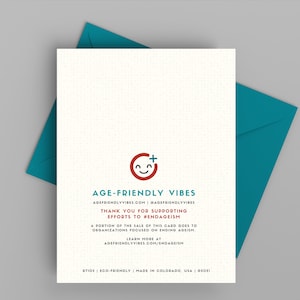 May include: A white card with a red and blue logo of a smiling face with a plus sign. The text "AGE-FRIENDLY VIBES" is in blue and red. The text "AGEFRIENDLYVIBES.COM | #AGEFRIENDLYVIBES" is in blue. The text "THANK YOU FOR SUPPORTING EFFORTS TO #ENDAGEISM" is in red. The text "A PORTION OF THE SALE OF THIS CARD GOES TO ORGANIZATIONS FOCUSED ON ENDING AGEISM" is in blue. The text "LEARN MORE AT AGEFRIENDLYVIBES.COM/ENDAGEISM" is in blue. The text "ATIDS | ECO-FRIENDLY | MADE IN COLORADO, USA | #001" is in blue.