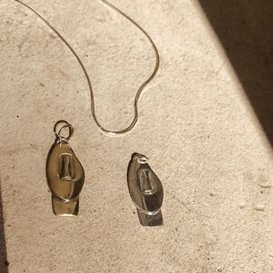 Cycladic style face pendant