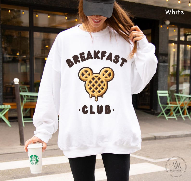 May include: White sweatshirt with a waffle Mickey Mouse design and the text "Breakfast Club".