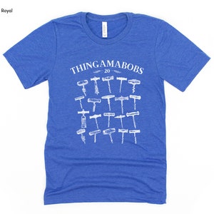 May include: A royal blue t-shirt with a white graphic of the text "Thingamabobs 20" and an assortment of 20 different corkscrews.