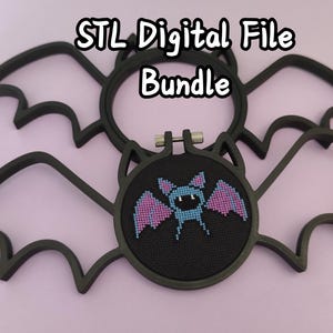 May include: Two black bat-shaped embroidery hoops, one empty and one containing a cross-stitch of a blue and purple bat on black fabric. The text "STL Digital File Bundle" is centered at the top. The hoops feature pointed ears and wings.