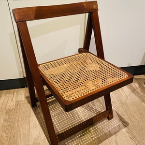 A pair of vintage rattan folding chairs