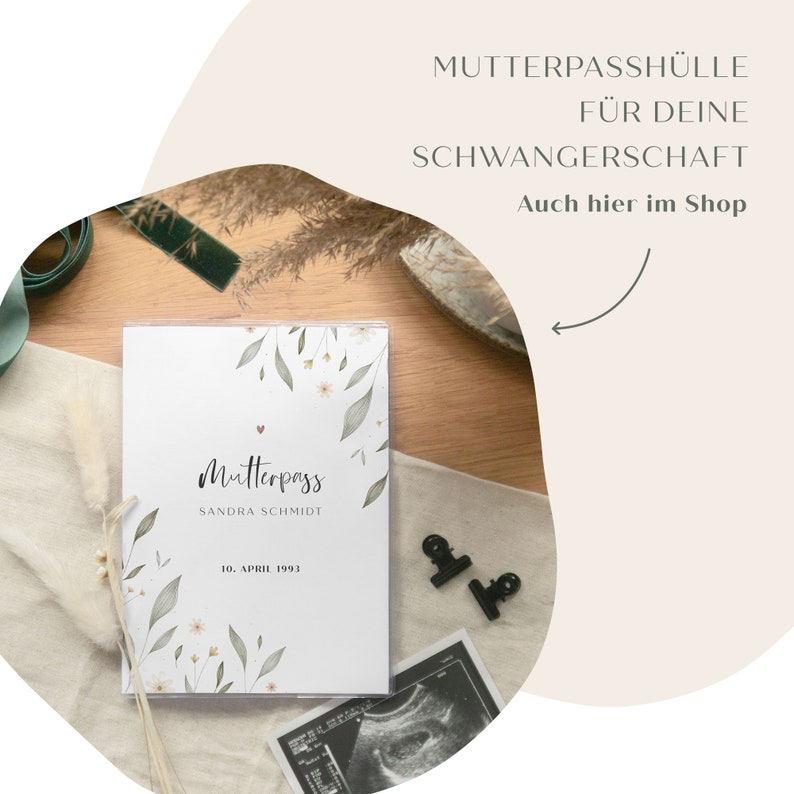 May include: A white cover for a pregnancy journal with a floral design and the text "Mutterpass Sandra Schmidt 10. April 1993".