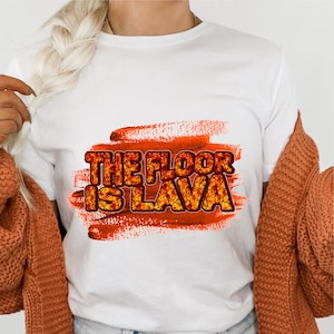 May include: White t-shirt with an orange and red graphic that says "The Floor Is Lava".