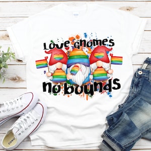 May include: White t-shirt with a rainbow-colored gnome design. The gnomes are holding rainbow flags and the text "Love gnomes no bounds" is printed on the shirt.
