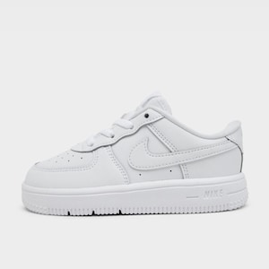 May include: White leather sneaker with a low-profile design. Features a perforated toe box, a Nike swoosh on the side, and the word "NIKE" on the sole. The shoe has a thick, textured sole.