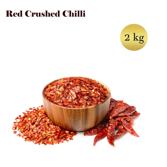rouge le Chili poivre flocon ou sol poudre grossier dans bois bol