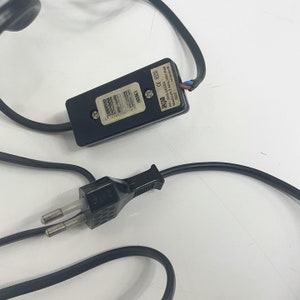 May include: Black electrical cord with a black plug and a black inline switch. The switch has the text "JAFE" and "AC: 230V~ 50Hz 350W Max." printed on it.