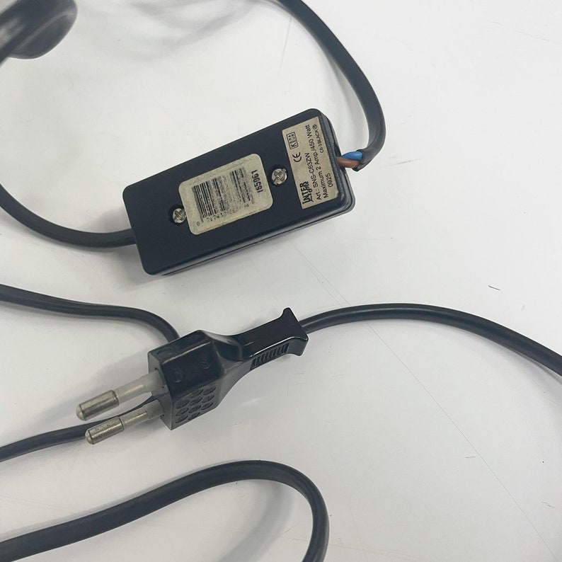 May include: Black electrical cord with a black plug and a black inline switch. The switch has the text "JAFE" and "AC: 230V~ 50Hz 350W Max." printed on it.
