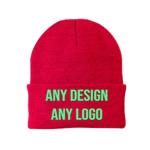 May include: Red knitted beanie with the text "ANY DESIGN ANY LOGO" in green.