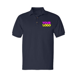 May include: A navy blue polo shirt with a yellow "YOUR LOGO" text in pink letters.