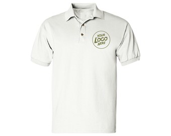 May include: White polo shirt with short sleeves and a collar. The shirt has three brown buttons and a green circular logo that says "YOUR LOGO HERE".
