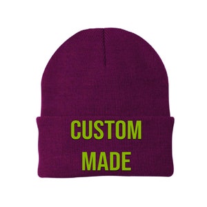 May include: A purple beanie with the text "CUSTOM MADE" in green.