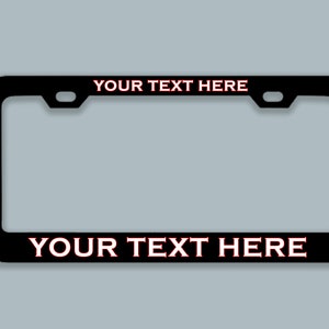 May include: Black license plate frame with red text that says "YOUR TEXT HERE" on the top and bottom.