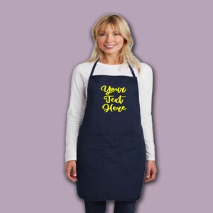 May include: A navy blue apron with a large yellow pocket and the text "Your Text Here" in yellow.