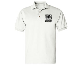 May include: White polo shirt with short sleeves and a button-down collar. The shirt has a small black embroidered logo on the left chest that says "YOUR LOGO HERE".