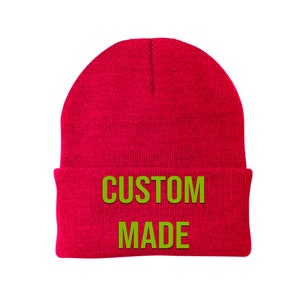 May include: Red knitted beanie with the words "CUSTOM MADE" in green lettering.