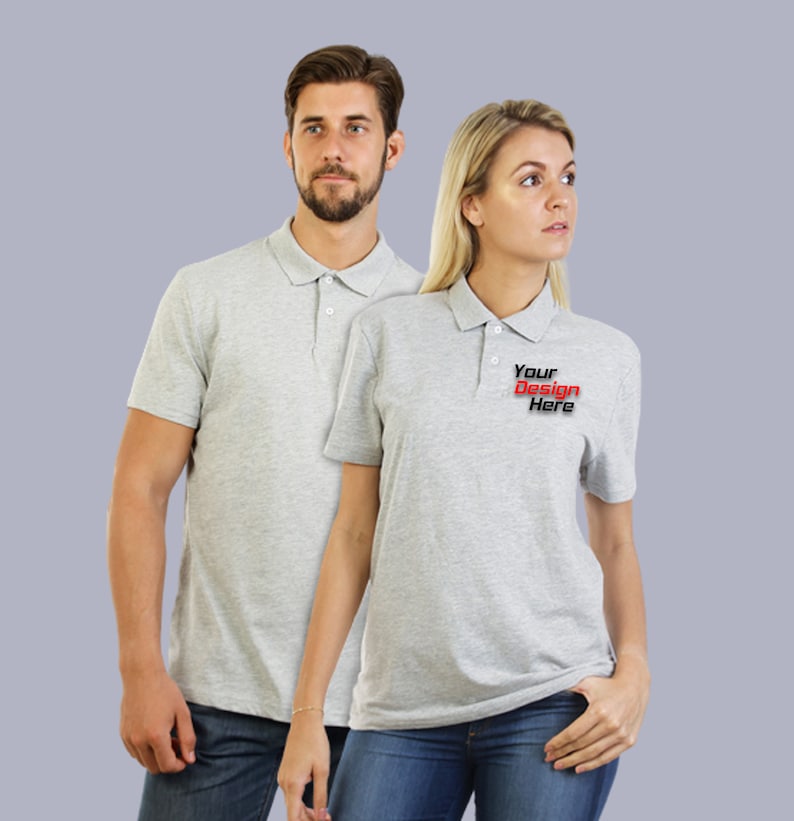 May include: Two gray polo shirts, one with the text "Your Design Here" in red and black lettering.