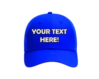May include: A vibrant blue baseball cap with a curved brim and mesh back. The front of the cap features the text "YOUR TEXT HERE!" in bold white letters with a black outline, perfect for customization.