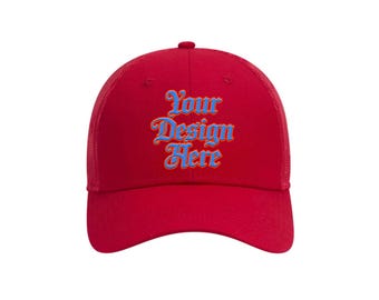 May include: A red baseball cap with a mesh back and a curved brim. The front of the cap features the text "Your Design Here" in blue script with an orange outline. The cap has a button on top.