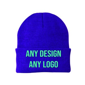 May include: A blue knitted beanie with the text "ANY DESIGN ANY LOGO" in green.