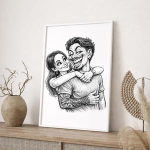 May include: A framed black and white cartoon illustration of a couple embracing. The man has a large smile and tattoos on his arm. The woman is smiling and has her arms around the man. The artwork is displayed on a wooden surface.