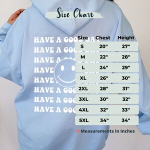 May include: A light blue hoodie with a white smiley face and the text "Have a Good Day" repeated multiple times. A size chart is included with measurements in inches for sizes S through 5XL.