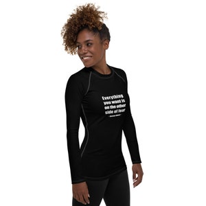 May include: Black long-sleeve shirt with a white quote that reads "Everything you want is on the other side of fear" - George Addair.