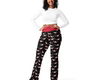 May include: Black yoga pants with a red waistband and a repeating pattern of white and red smiling cat faces.