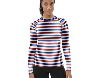 May include: A long-sleeved shirt with a white, red, and blue striped pattern. The shirt has a crew neck and a fitted silhouette.