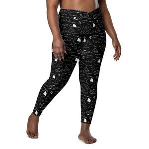 May include: Black leggings with a white print of mathematical equations, symbols, and diagrams. The print includes the symbol for pi.