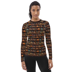 May include: A long-sleeved shirt with a pattern of a bookshelf filled with glass bottles and jars. The shirt is black with a brown and gold bookshelf pattern.