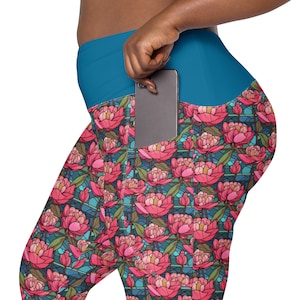 May include: Teal blue leggings with a large side pocket and a floral pattern of pink peonies on a blue and green background.