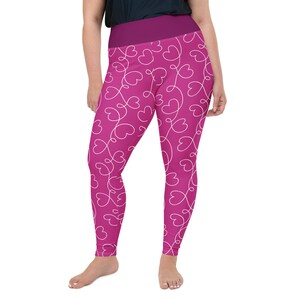 May include: Plus-size leggings in a vibrant magenta hue, adorned with a white heart-shaped pattern. The leggings feature a wide, solid magenta waistband. The design is a playful and stylish choice for activewear or casual outfits.