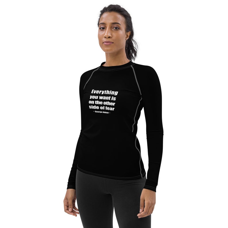 May include: Black long-sleeve shirt with a white quote that reads "Everything you want is on the other side of fear - George Addair".