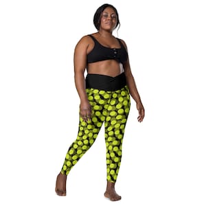 May include: Black leggings with a high waist and a yellow polka dot pattern. The leggings are made of a stretchy, comfortable fabric.