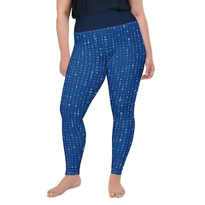 May include: Plus-size leggings in a vibrant blue hue, patterned with a digital binary code design. The leggings feature a high waistband in a darker shade of blue, offering a comfortable and stylish fit. These leggings are perfect for casual wear or workouts.