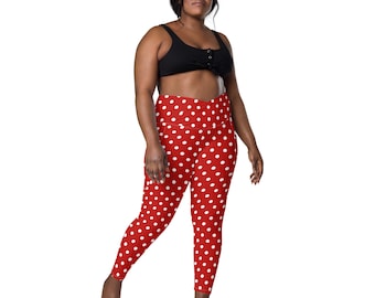 May include: Red leggings with a white polka dot pattern. The leggings have a high waist and a flattering fit.