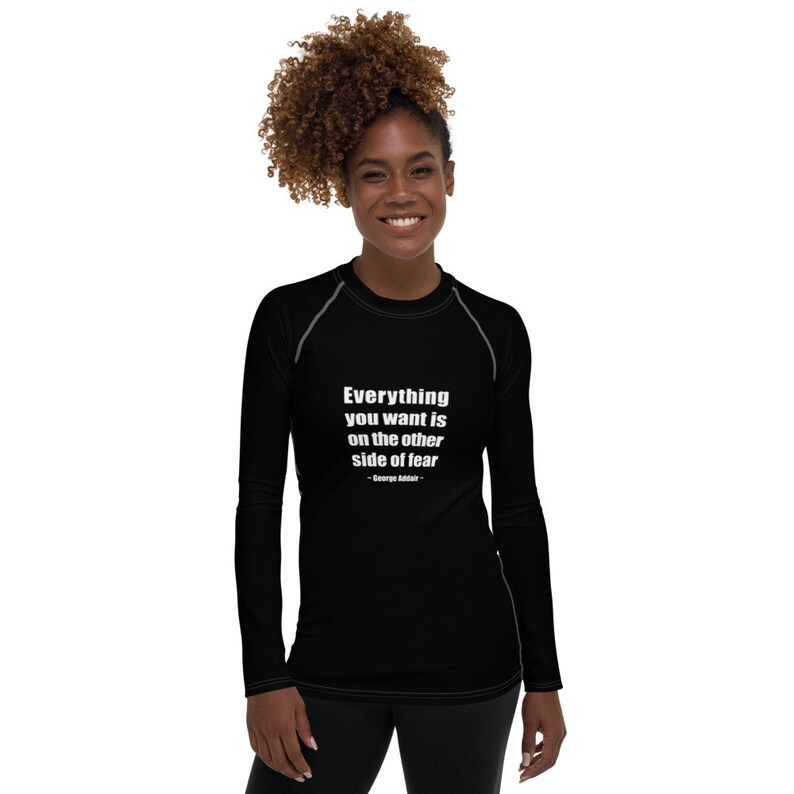 May include: Black long-sleeve shirt with a white quote that reads "Everything you want is on the other side of fear - George Addair".