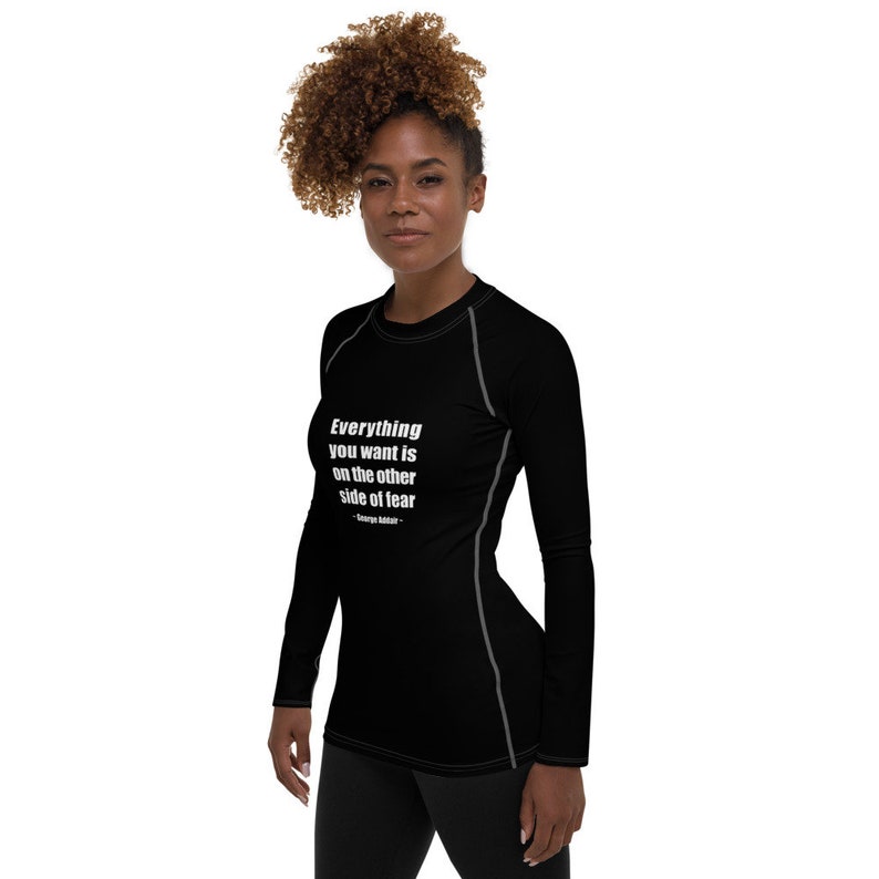 May include: Black long-sleeve shirt with a white quote that reads "Everything you want is on the other side of fear - George Addair".