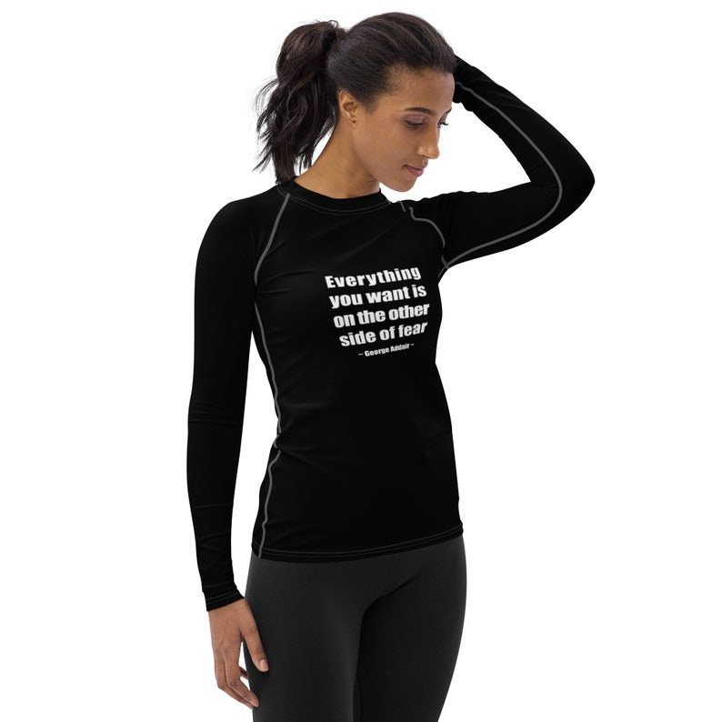 May include: Black long-sleeve shirt with a white quote that reads "Everything you want is on the other side of fear - George Addair".