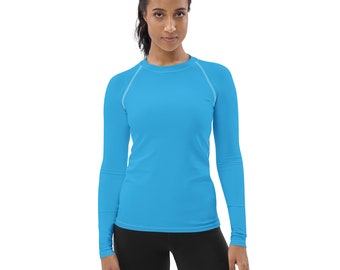 May include: A long-sleeved shirt in a bright blue color with white stitching around the neckline and shoulders.