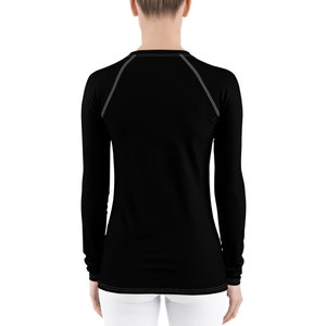 May include: Black long-sleeved shirt with a crew neck and gray stitching around the neckline.