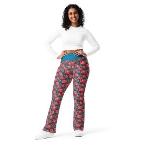 May include: A woman wearing a white long-sleeved shirt and black and pink floral print leggings with a teal waistband.