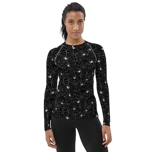 May include: Black long-sleeved shirt with a white spiderweb and spider pattern.