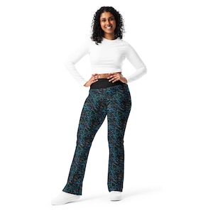May include: A woman wearing black and blue patterned leggings with a black waistband. The leggings have a bootcut style.