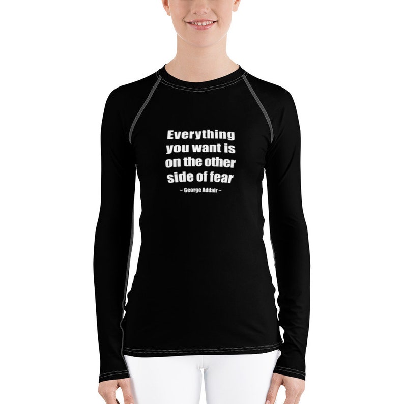 May include: Black long-sleeve shirt with a white quote that reads "Everything you want is on the other side of fear - George Addair -"